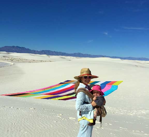 Rachel in White Sands with her work and daughter.